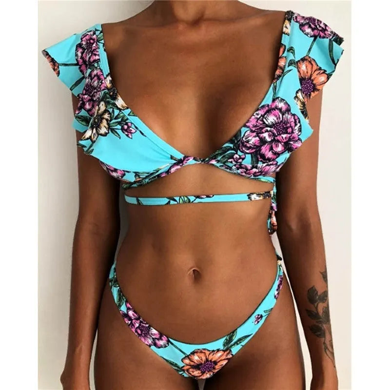 Yellow floral print split bikini swimsuit set on a mannequin, showing backless design.