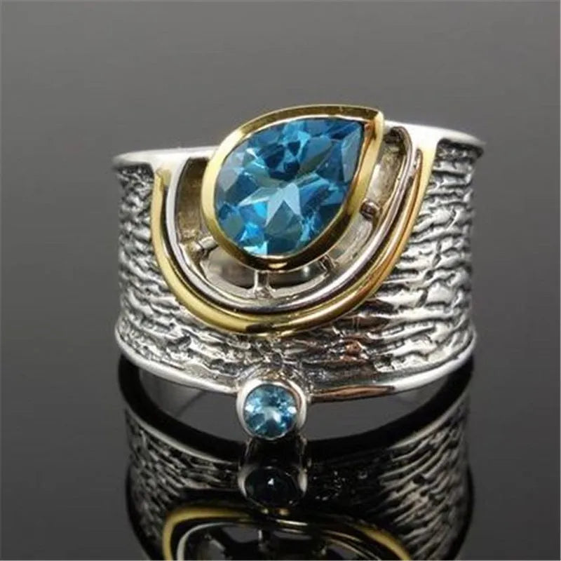 Blue zircon Chinese style women's ring with inlaid design showing drop shape silhouette