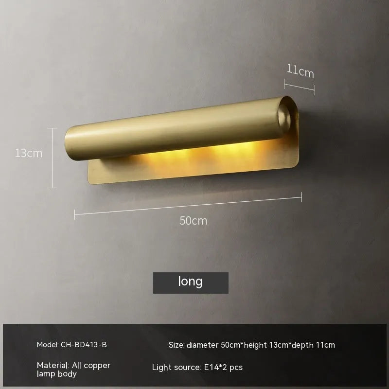 Simple modern copper wall lamp with warm light, 26cm long, on a living room wall