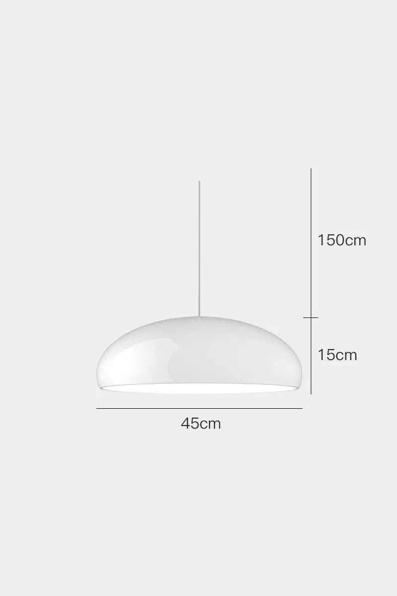 Danish iron pendant lamp in orange with adjustable cable hanging over a restaurant table.