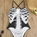 Women's one-piece swimsuit with black and white skeleton print, polyester lining, sizes S to XL.