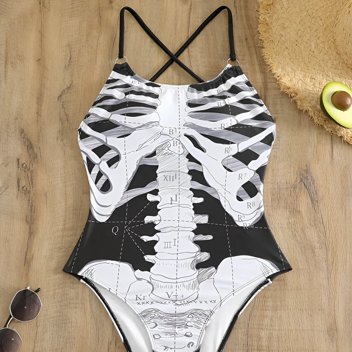 Women's one-piece swimsuit with black and white skeleton print, polyester lining, sizes S to XL.