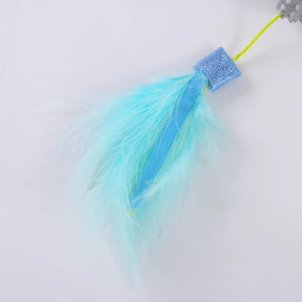 Blue cat toy wand with double haired prick head and suction cup base on a window