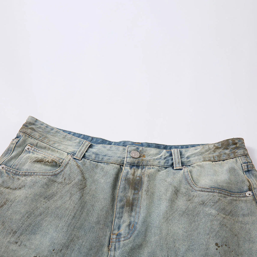 Blue washed straight leg denim trousers showing mid-length cut and zipper fly detail