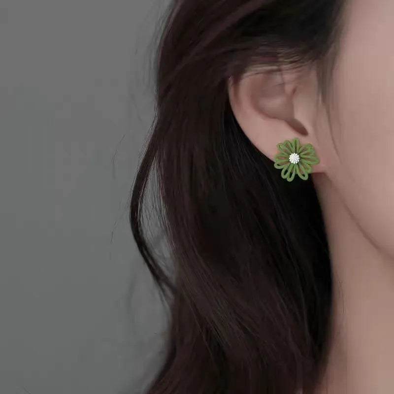 Two-tone flower stud earrings in blue and orange colour combination with cartoon floral design