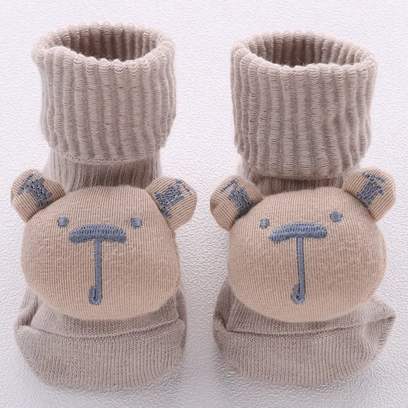 Cotton baby floor socks in various colours and patterns including pink bows, grey stars, and panda design.