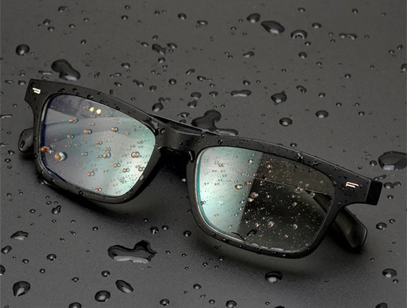 Smart sunglasses with black frame, polarised lenses, and built-in Bluetooth speakers in the temples.