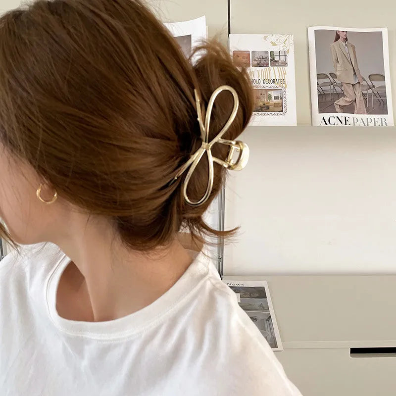 Gold bow barrette hair grip with alloy construction and decorative design