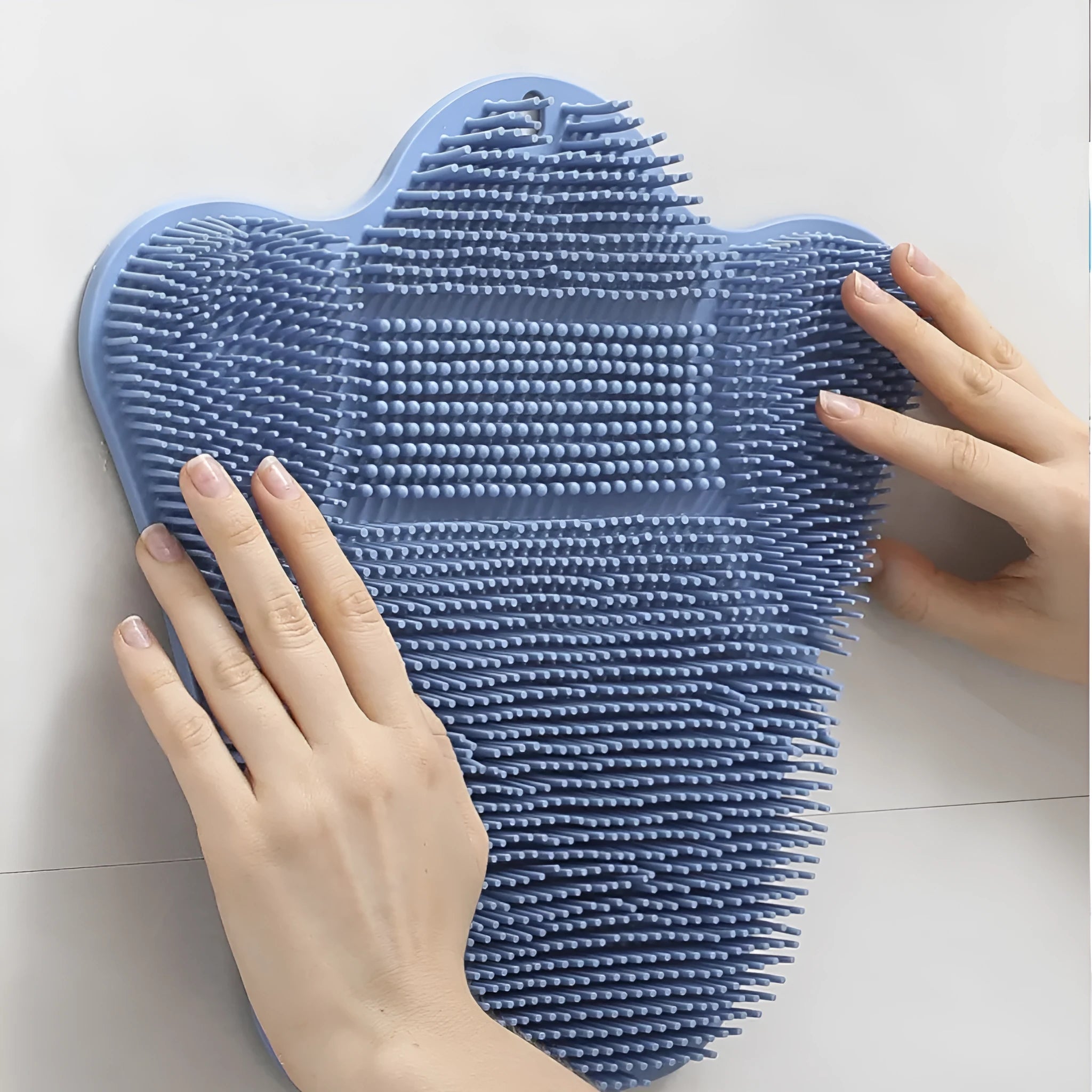 Blue silicone bath massage mat with textured surface for grip and skin stimulation