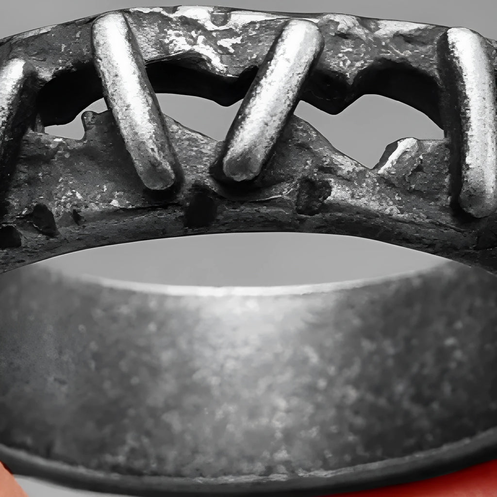 Dark punk style stainless steel double band ring on a hand, showing textured stitching detail.