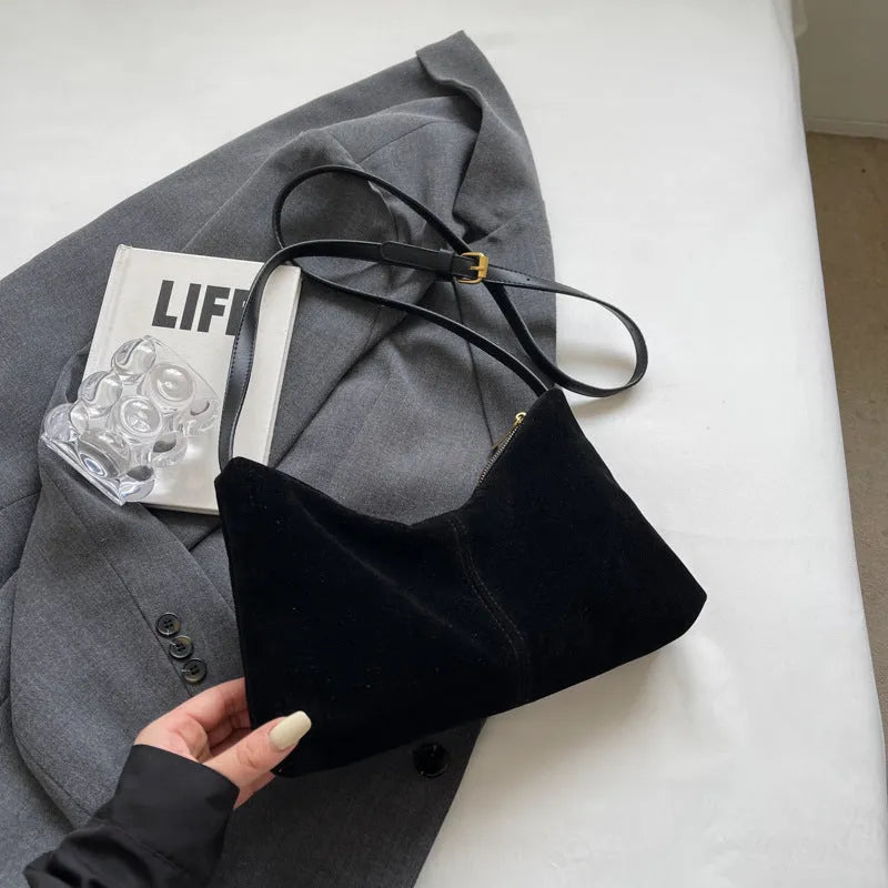 Retro suede underarm bag in black with bucket shape, sandwich pocket, and visible sewing detail