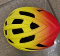 Orange road bike mountain riding helmet with 16 vents and In Mold construction on white background