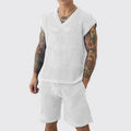 Men's blue V-neck knitted vest and matching shorts sports set laid flat.