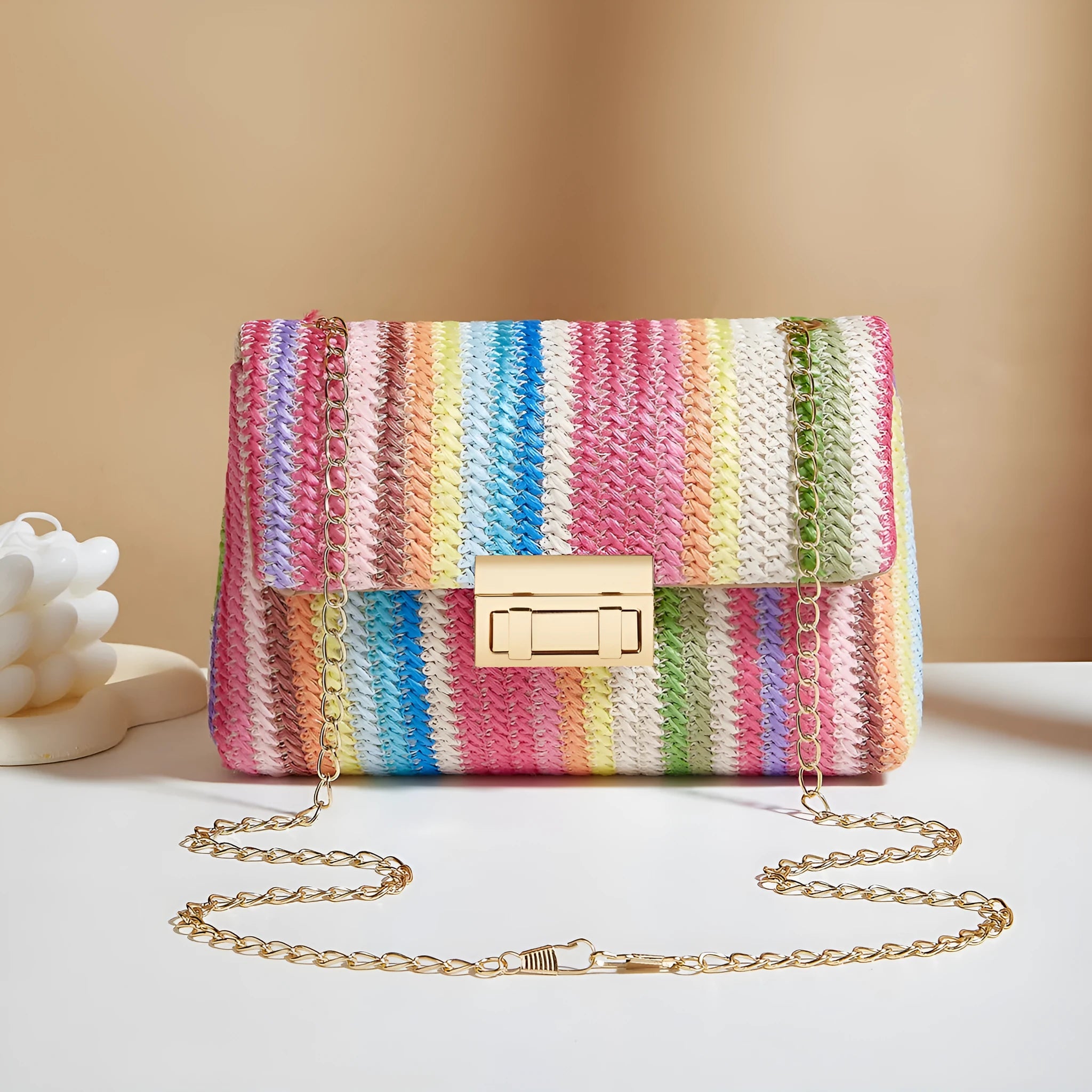 Women's soft straw cross-body bag in small horizontal square shape showing internal mobile phone compartment