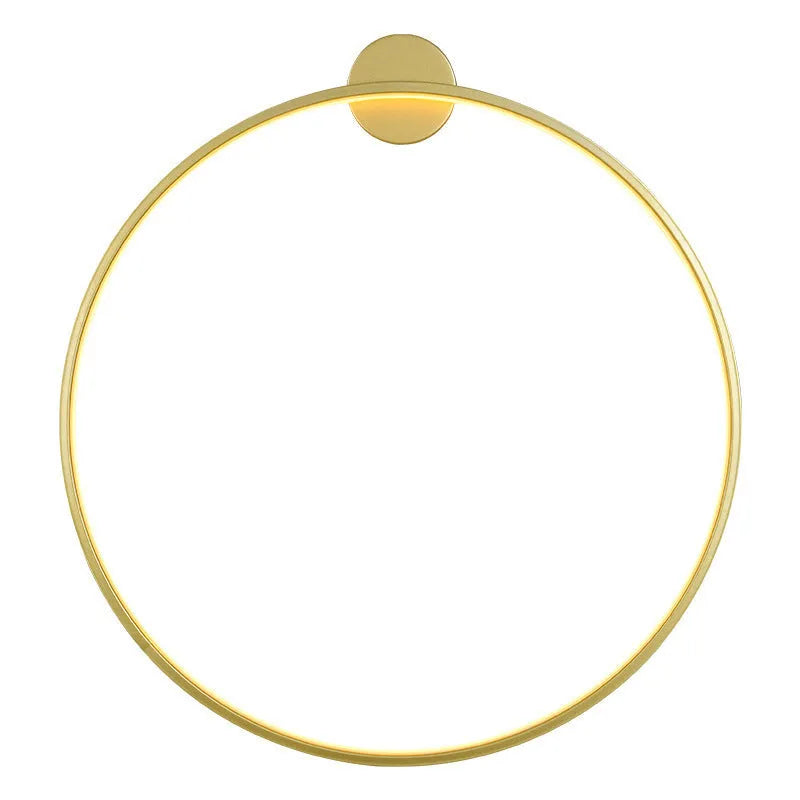 Minimalist black ring wall lamp with acrylic shade mounted on a bedroom wall