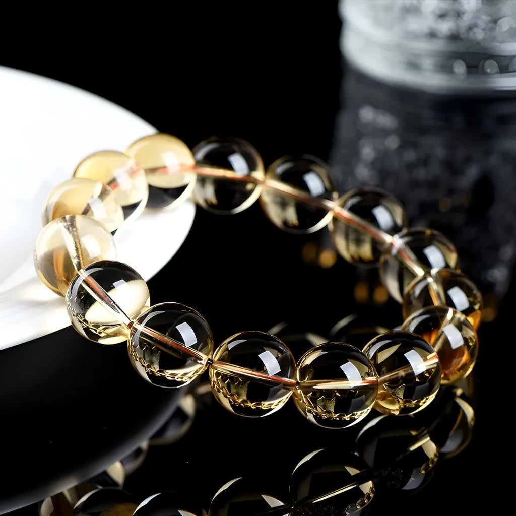 Natural honey-yellow citrine bead bracelet with hand-knotted cord, shown in scattered bead style.