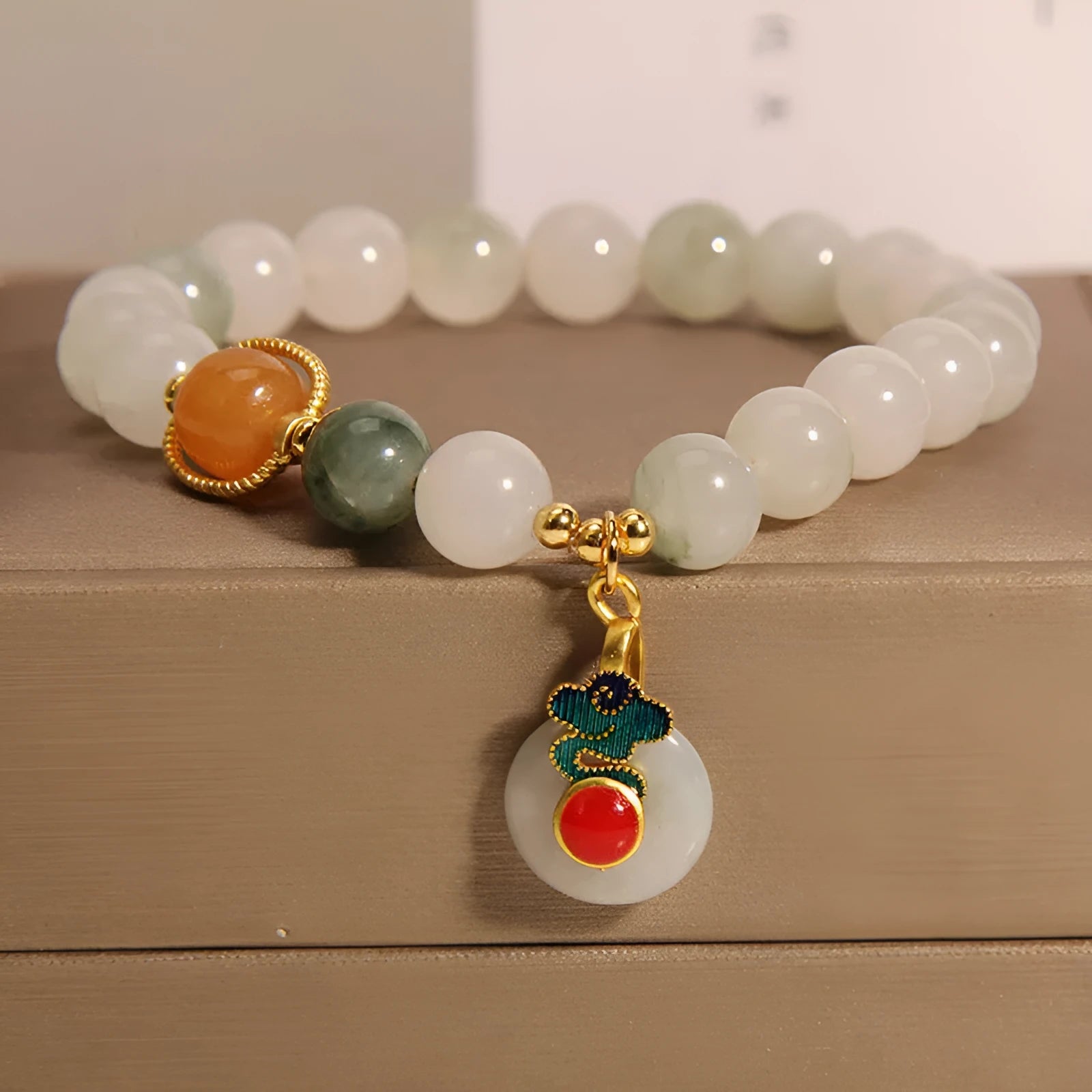 Women's ice jade crystal bracelet with a pearl and a detailed Xiangyun peace jade buckle.