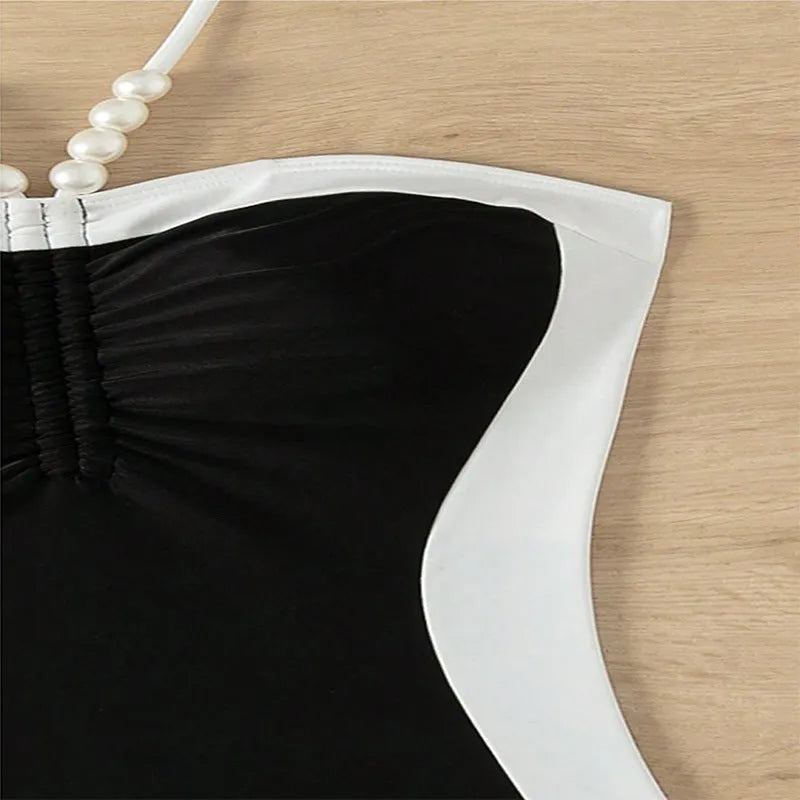 Black and white women's one-piece swimsuit with pearl spaghetti straps, slim fit for swimming.