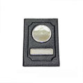 Black synthetic leather passport case with expandable design and aluminum lenses on a plain background
