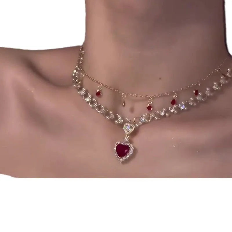 Red love heart pendant on a double layer alloy necklace with an adjustable chain.
