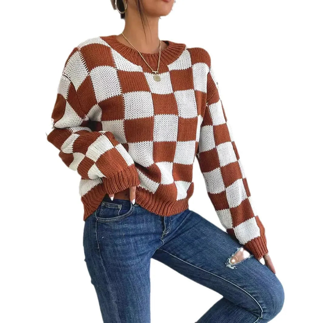 Dark brown plaid loose fit acrylic pullover sweater with long sleeves on a hanger.