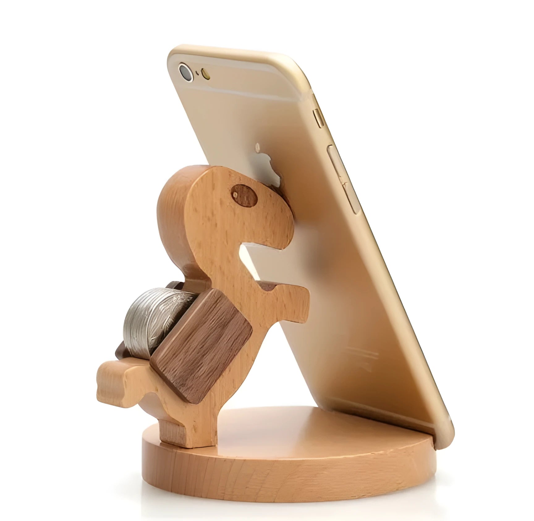 Solid beech wood phone stand with a decorative resin puppy figurine, holding a mobile phone at an angle with a charging cable threaded through the back.