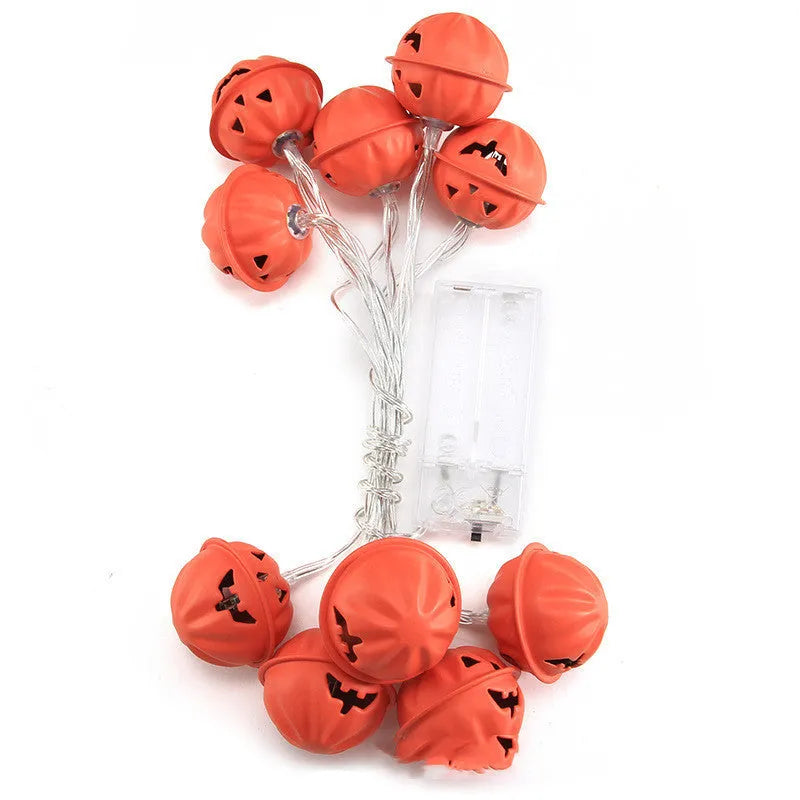 LED Halloween string lights with warm white glow and iron pumpkin pendants on a dark background