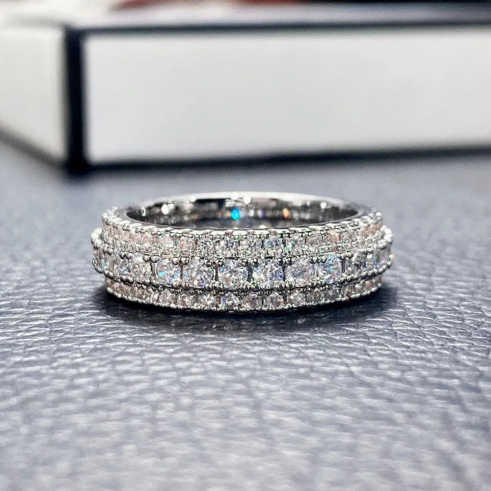 A geometric copper ring with a triangular zircon stone inlay, shown in a white gold colour finish.