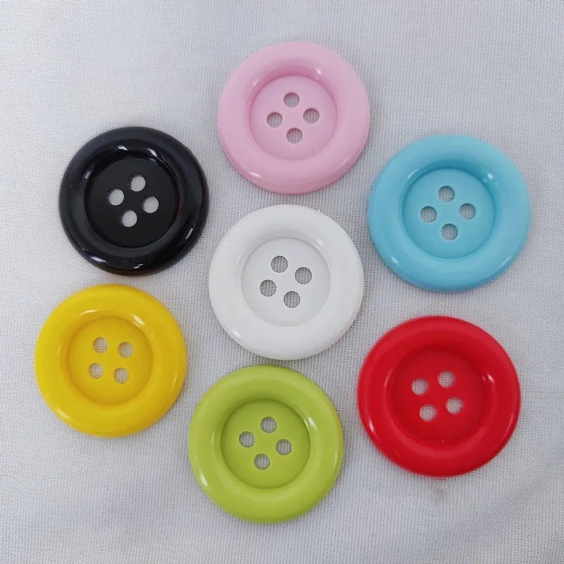 Oversized plastic round edge button with four holes in assorted colours and sizes