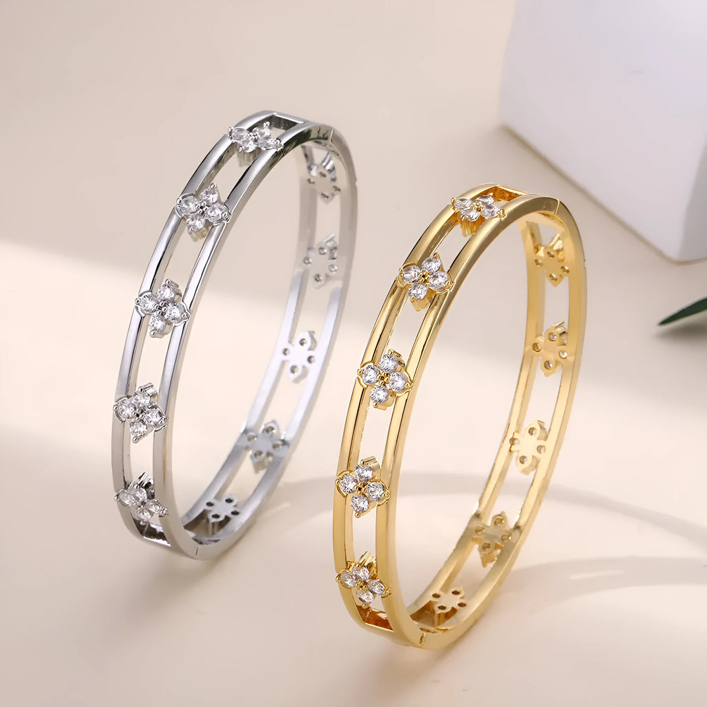 Gold and silver hollow women's bracelet with zircon four-leaf clover and grass petal charm.