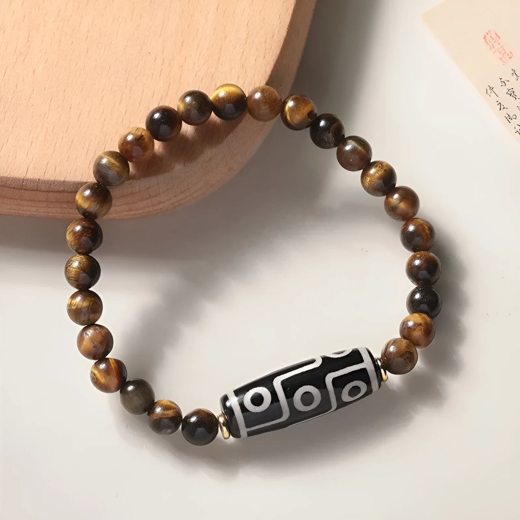 Single strand tigereye Buddha bead bracelet with dzi pattern on wrist, showing 10mm bead size.