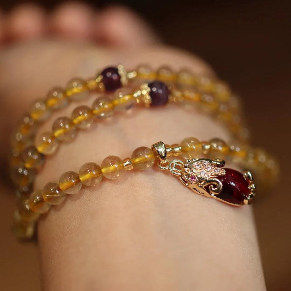Natural Brazilian rutilated quartz bracelet in Chinese style with three circles and hanging chopsticks.