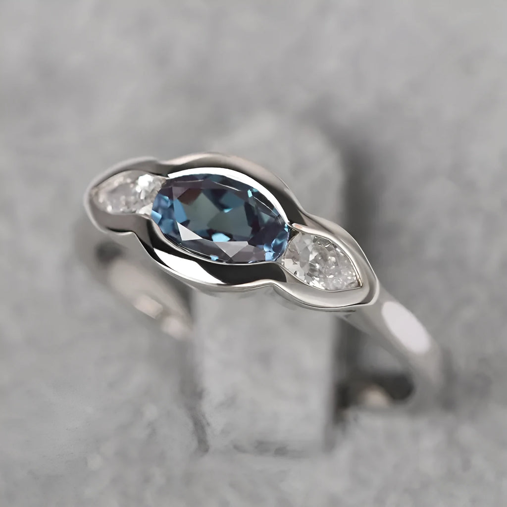 Geometric ellipse ring with zircon inlay in white gold colour, showing contemporary jewellery design