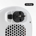 White ceramic heating electric heater with remote control on a table.