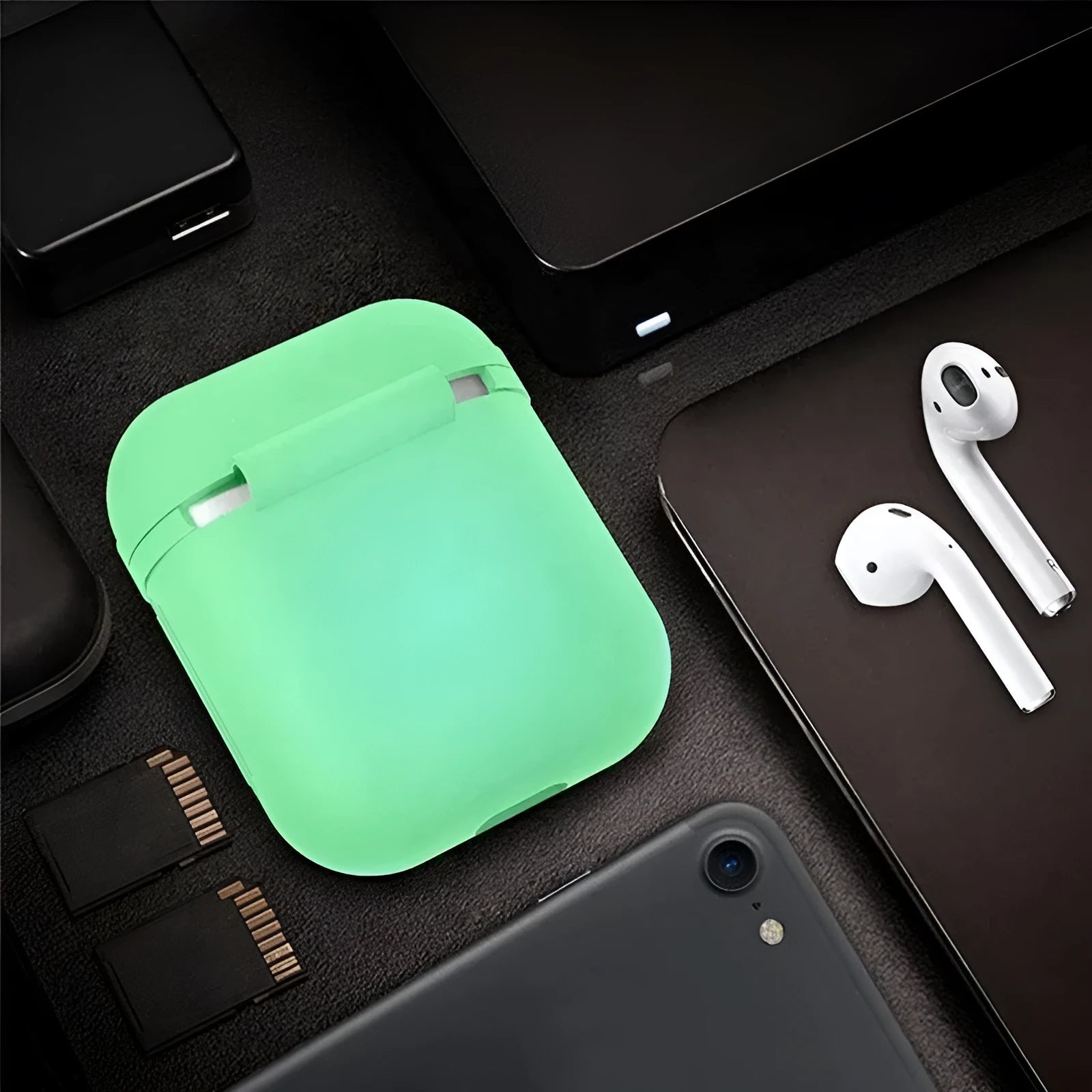 Glow-in-the-dark silicone flip cover case for Apple AirPods charging case on a dark background