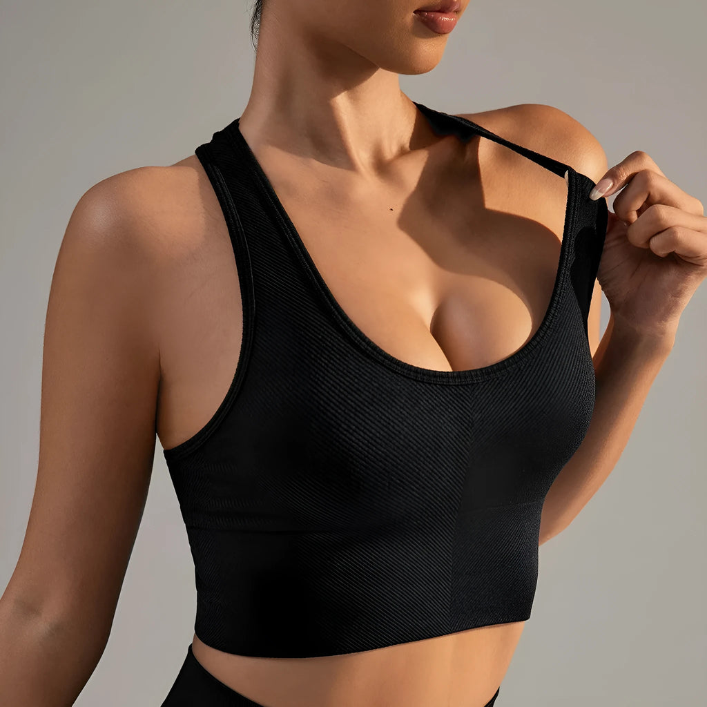 Black women's cross-back sports bra with fixed double straps and moulded cups.