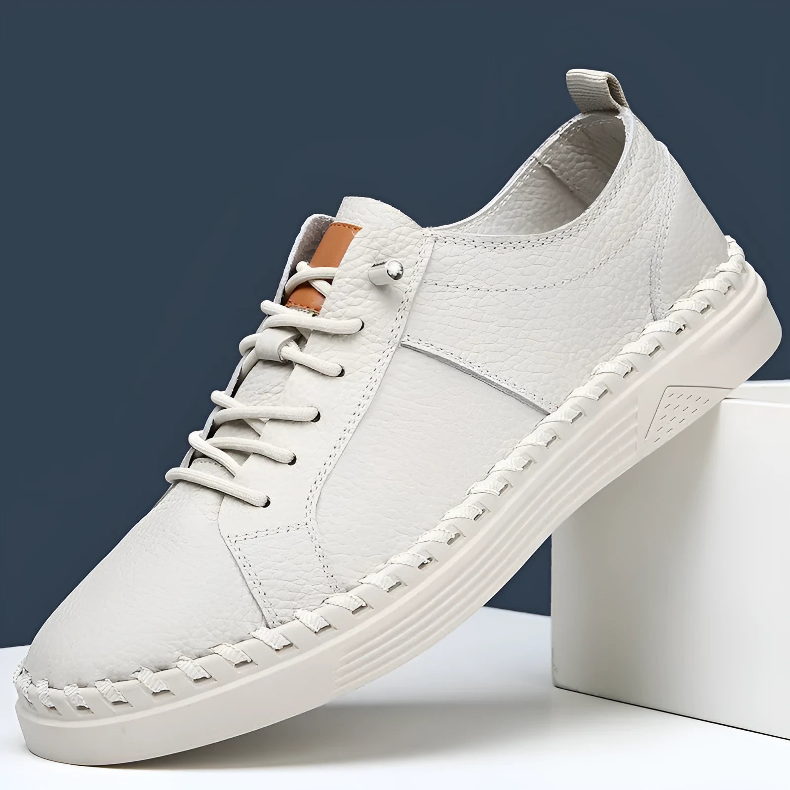 Men's beige and black round toe casual sneakers made from first layer cowhide with visible stitching.