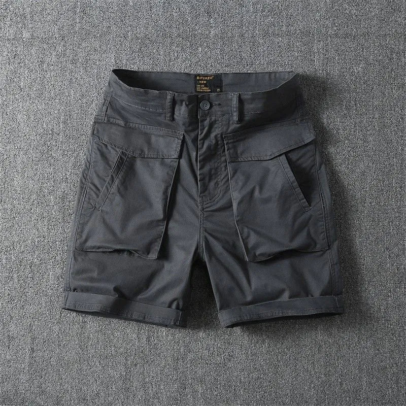 Men's straight-leg cotton cargo shorts in khaki with multiple pockets, shown on a model for summer street style.