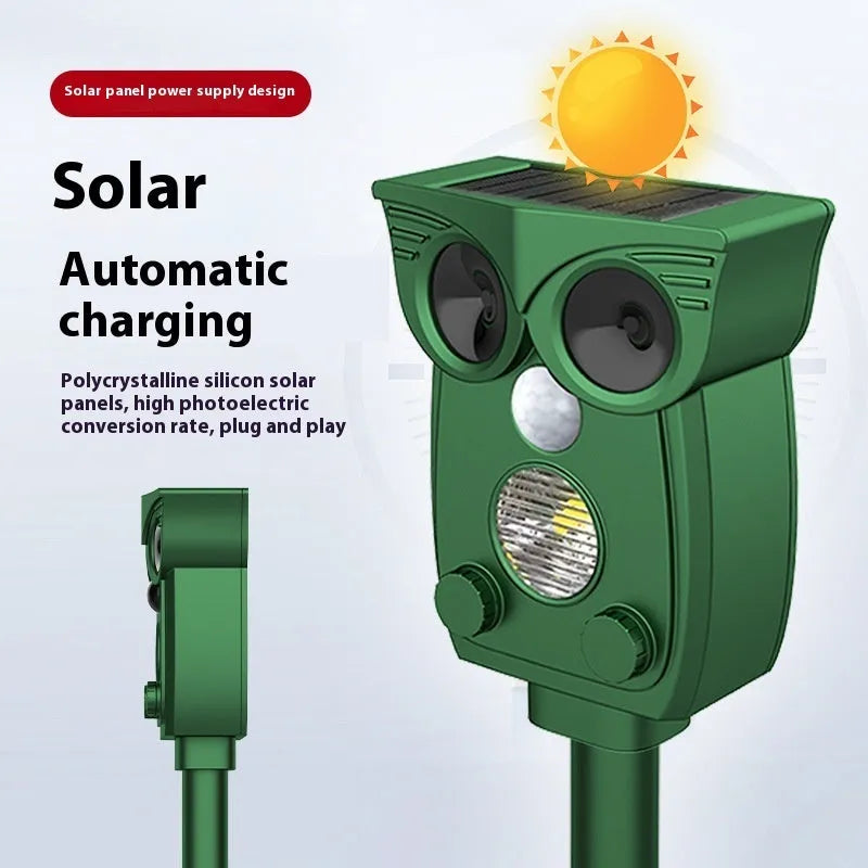 Dark green solar-powered animal repeller with infrared sensor on a garden lawn