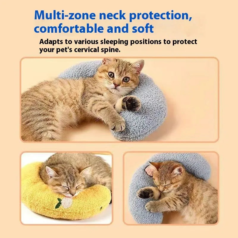 Blue U-shaped cat pillow with neck support in a moon design on a wooden floor.