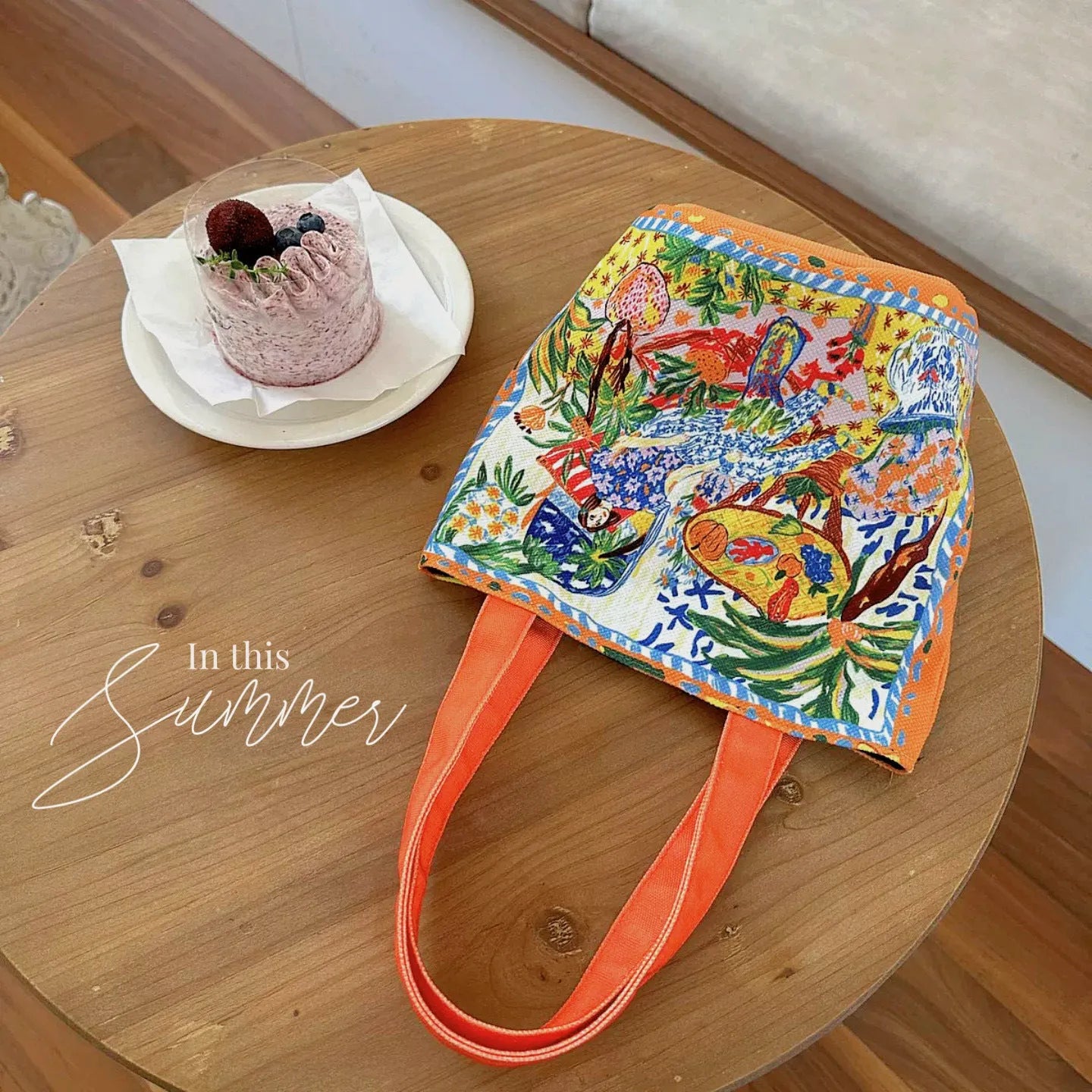 Orange canvas bucket handbag with double shoulder straps and printed letter design