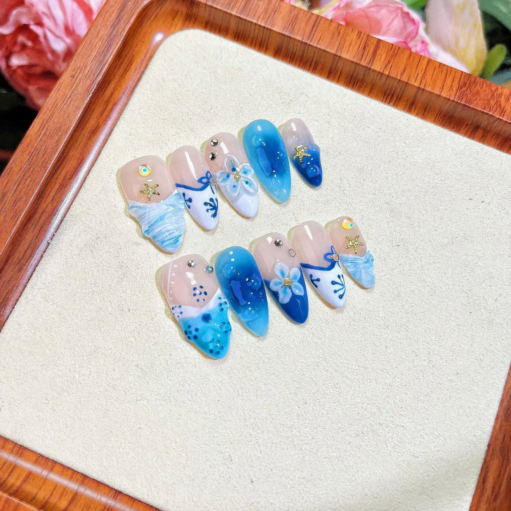 Blue false nails with hand-painted carved summer ice transparent design, shown in XS, S, M, L sizes.