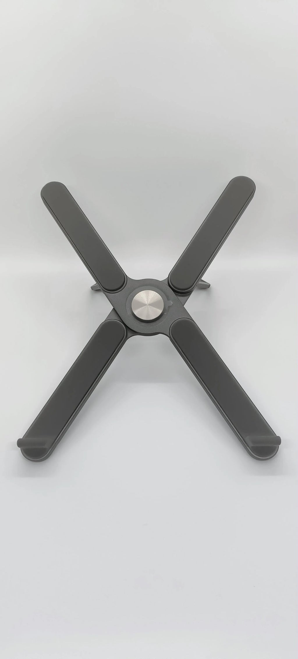 Foldable aluminium alloy laptop bracket in silver on a desk with notebook computer