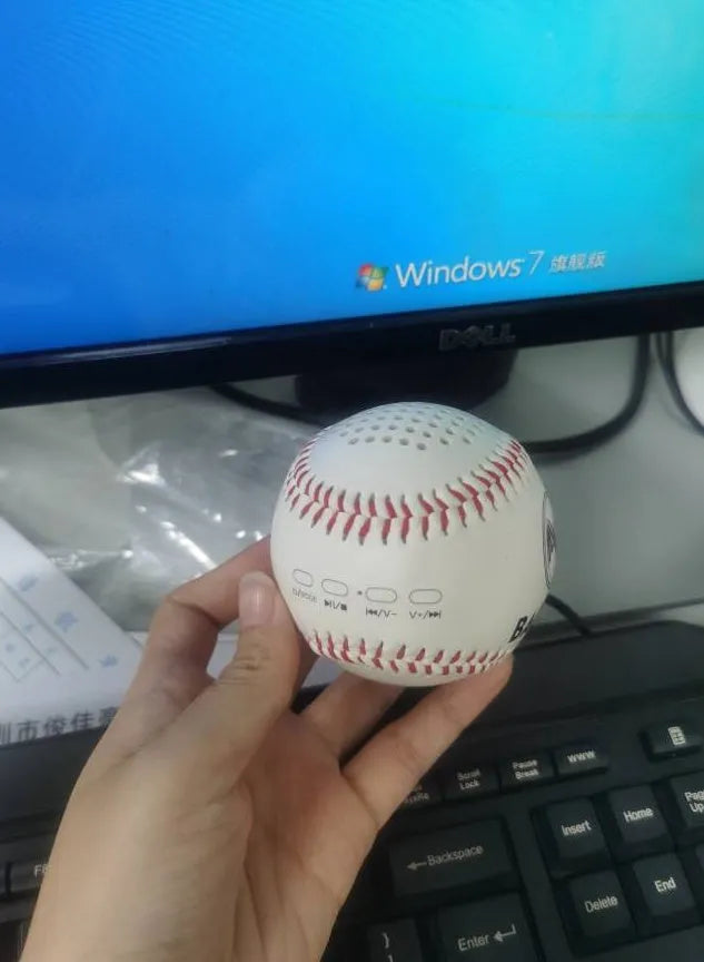 Baseball-shaped Bluetooth speaker in green colour with USB charging port