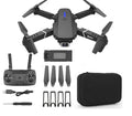 Grey foldable 4K dual camera drone with remote controller and carry bag, shown with propeller blades extended.