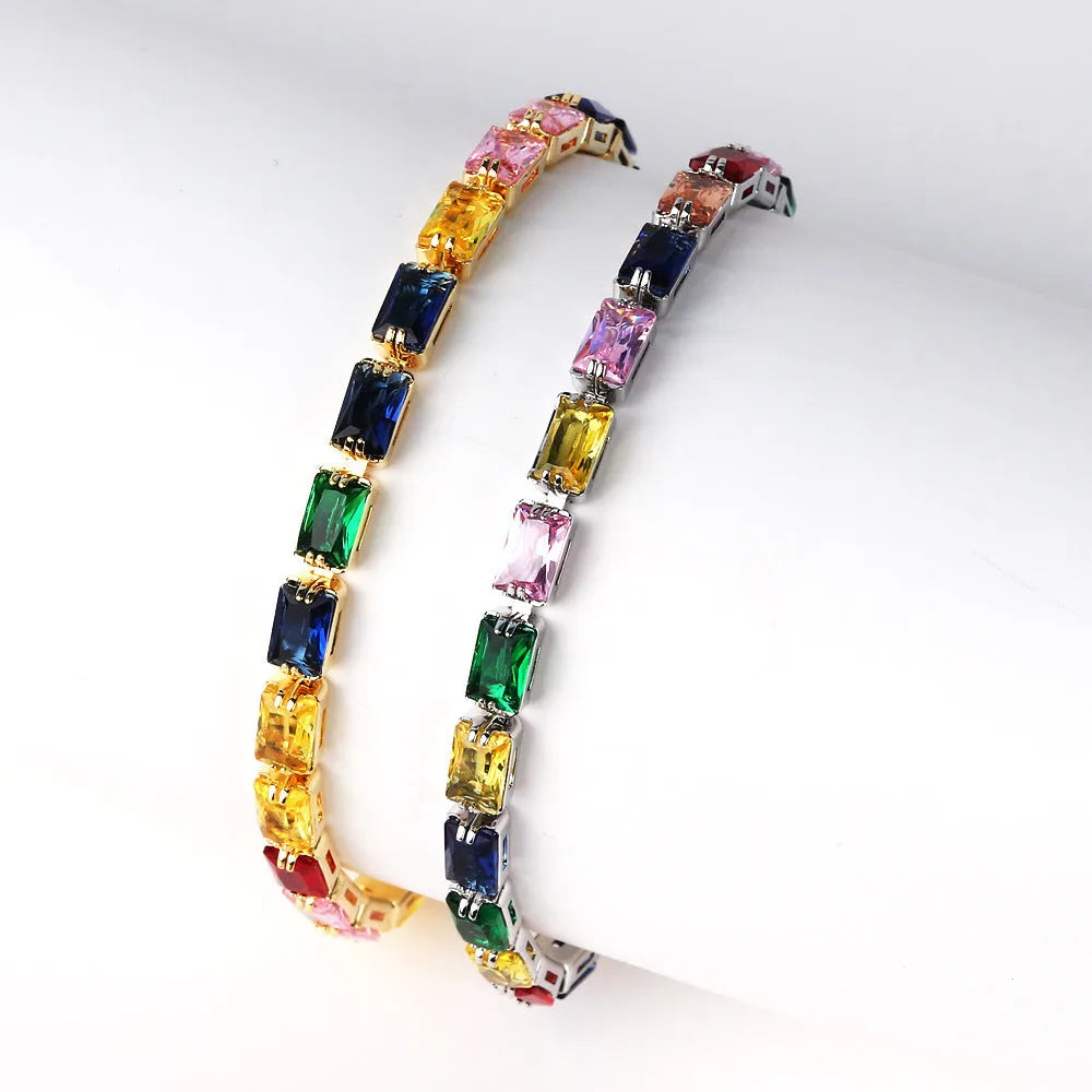 Women's fashion zircon bracelet in alloy with gold electroplated finish and coloured stone settings.