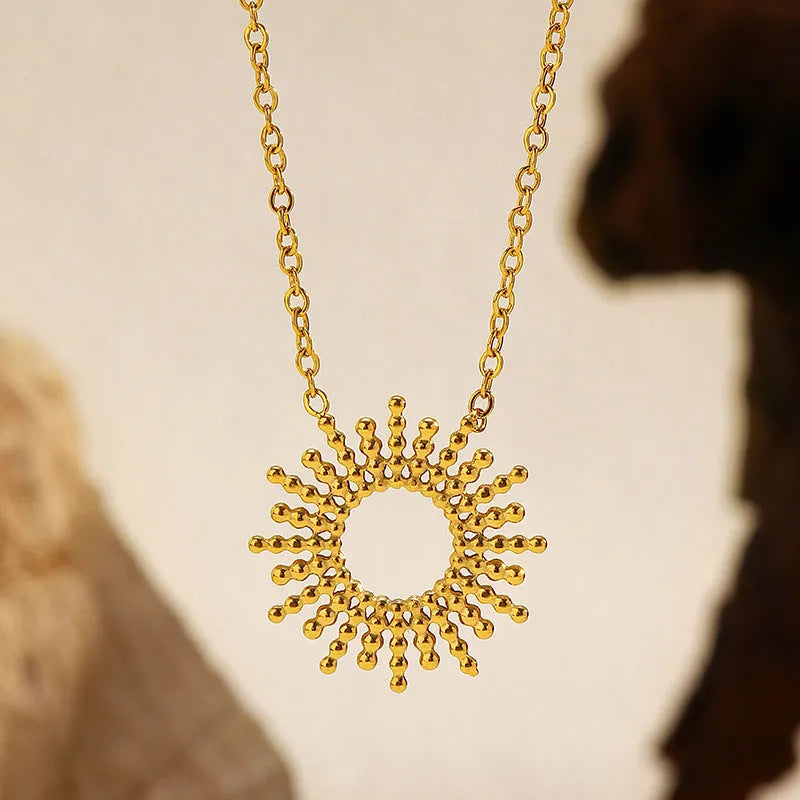 Gold geometric chain necklace and bracelet set for women on a plain background.