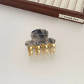 Medium metal grip women's barrette in retro acetate style, alloy acrylic construction, shown in one of four colour options.