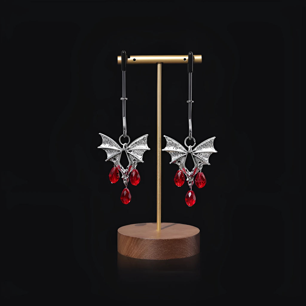 Silver alloy bat-themed nipple clamp with adjustable pressure and a red ruby decorative clip.