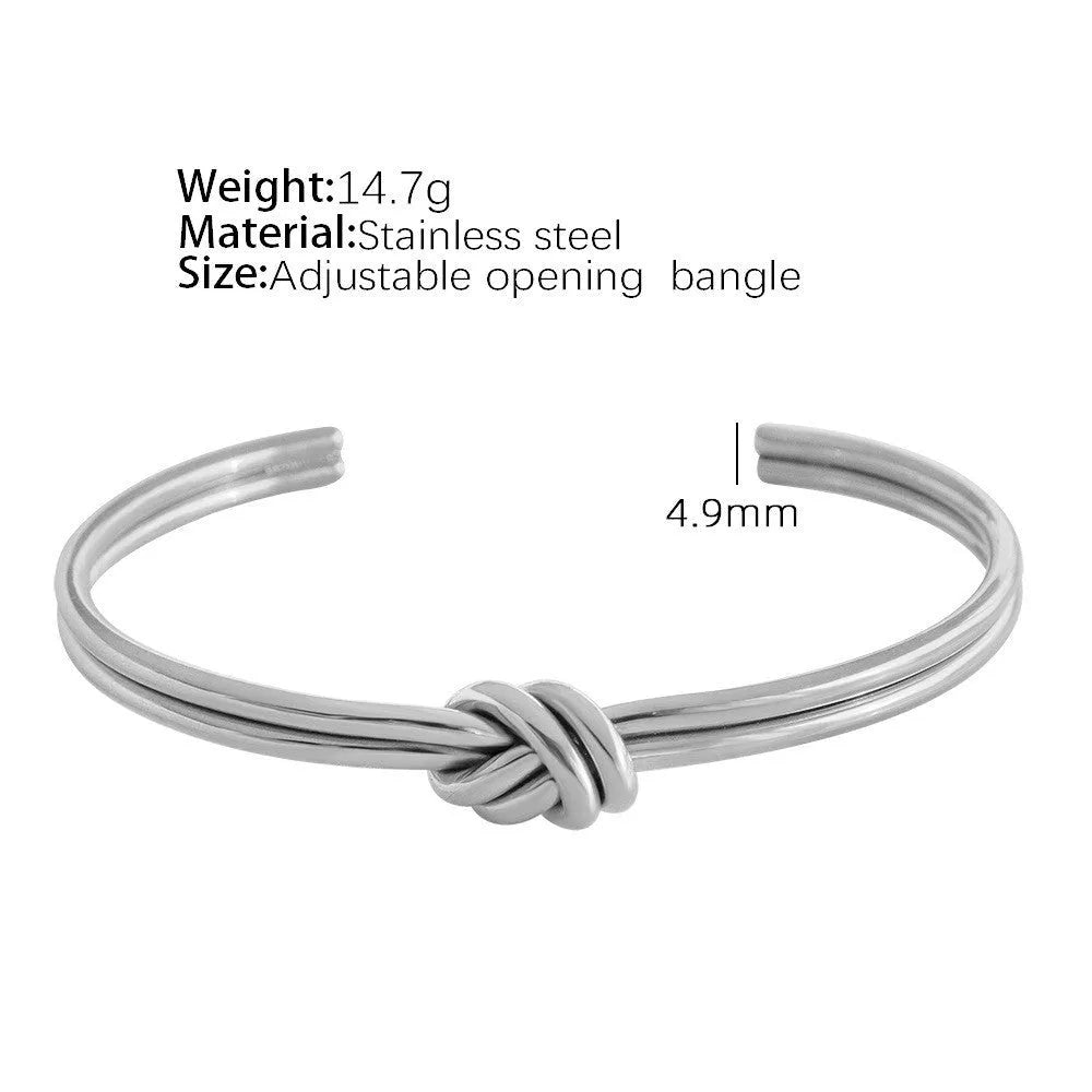Adjustable stainless steel bracelet with 18K gold plating and knotted C-shaped open design